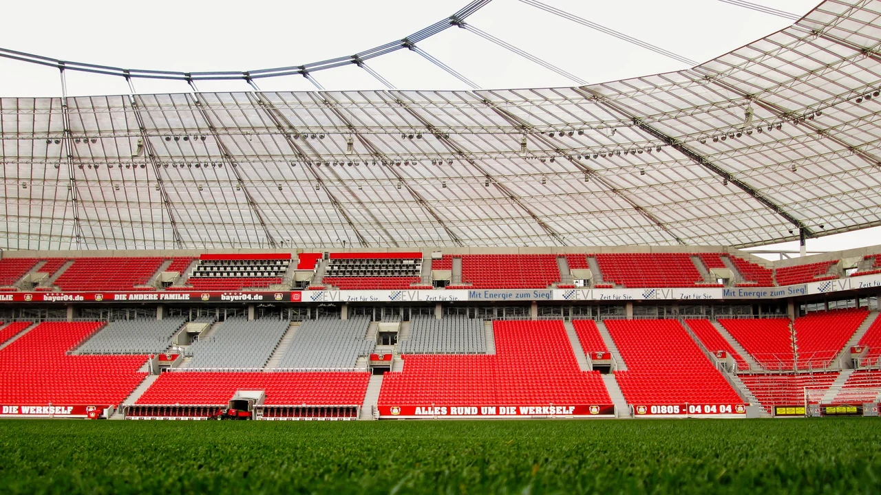 Innenansicht der BayArena in Leverkusen mit Dachkonstruktion und roten Rängen